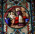 Franz von Sales besucht als Bischof Arme und Kranke. Glasfenster in der Alten Pfarrkirche Franz von Sales in Paris, Frankreich (Ausschnitt).